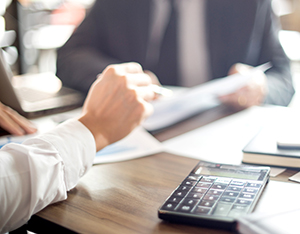 Businessman work with computer on table in office work with paper graph chart business marketing plan analysis