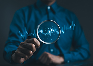 Stock trading and investing concept. Businessman or trader hand holding magnifying glass with virtual stock graph market chart. foreign exchange, trade fund, crypto money, Business growth, investor,