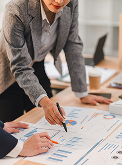 Business professionals analyzing financial charts and graphs during meeting, discussing data trends and strategies in modern office environment A Business professionals analyzing financial charts and graphs during meeting, discussing data trends and strategies in modern office environment