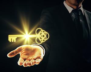 Man holding key Man holding ornate golden key on dark background. Success concept