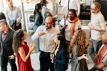Diverse group of people at social event, mingling and chatting. Diverse group of people at social event, mingling and chatting. Diverse crowd enjoy drinks and conversation in lively social gathering party. Social event with diverse group of people mingling