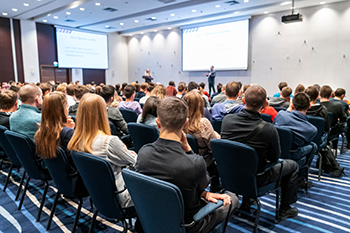 Image of a conference that takes place in a large conference roo Image of a conference that takes place in a large conference room, workshop for young professionals, training in a large conference room, adult training