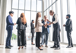 Group of multinational executives, men and women in suits, stand Group of multinational executives, men and women in suits, stand