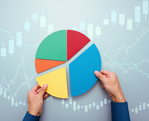 Strategy of diversified investment.  Investor managing portfolio. Pie chart and candlestick charts.
